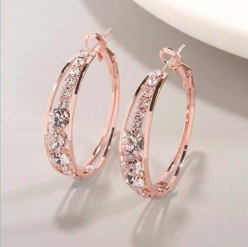 Elegant rose gold hoop earrings adorned with sparkling crystals, perfect for stylish women's accessories.