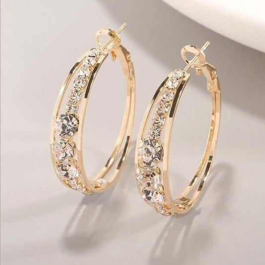 Gold hoop earrings embellished with sparkling crystals, elegant design for women's fashion jewelry.